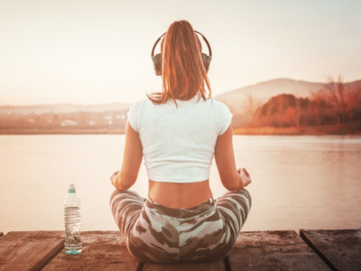 pre-workout meditation guide - women meditating by the water